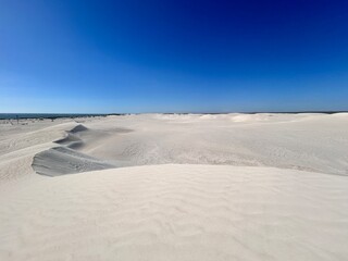 Lancelin, a coastal town in Western Australia, is famous for its white sand dunes, perfect for sandboarding, off-road adventures, pristine beaches, windsurfing, and a relaxed atmosphere.