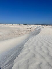 Lancelin, a coastal town in Western Australia, is famous for its white sand dunes, perfect for sandboarding, off-road adventures, pristine beaches, windsurfing, and a relaxed atmosphere.