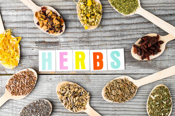 Stomach sign. Herbal collection in wooden spoons: chamomile, calendula, dill and milk thistle seeds.Wooden Spoons with Dried Chamomile, Calendula, and Seeds on White Background. 