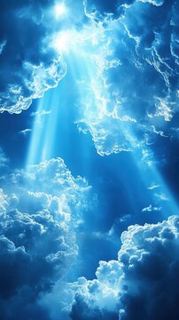 Beautiful sunlight streams through fluffy blue clouds in a serene sky.