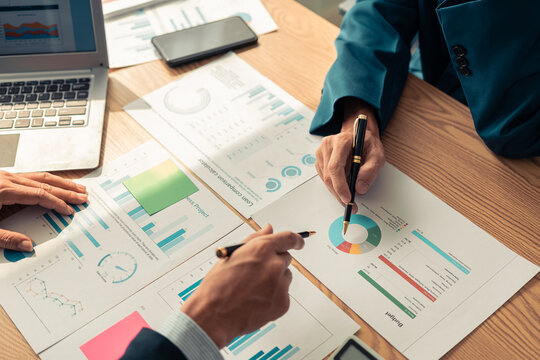 A meeting to review organizational compliance with experts reviewing documents. Investment advisor, strategy, planning, accounting concepts Business advisory group meets to analyze finances