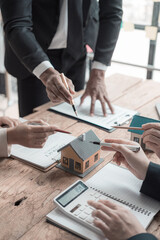 A real estate salesperson introduces a customer to a model home project and hands the keys to the...