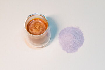 refreshing glass of Thai iced milk tea, served in a clear glass cup. The rich, vibrant orange color of the tea contrasts beautifully with the creamy milk at the bottom. A perfect blend