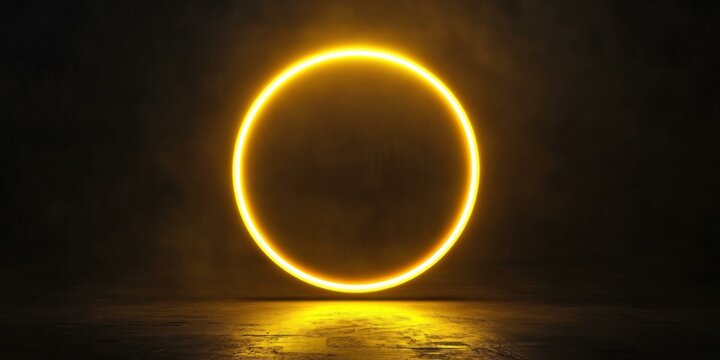 A thick neon circle glowing in radiant yellow, casting a faint light on a sleek black background