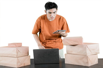 Entrepreneur Managing Online Orders with Laptop and Tablet