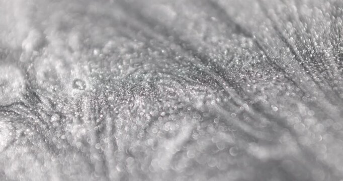 beautiful painting made mith many sliver round shapes glowing and moving