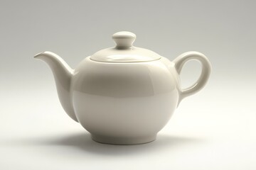 A simple, elegant white teapot with a smooth surface, featuring a curved spout and a matching lid, set against a minimalistic background.