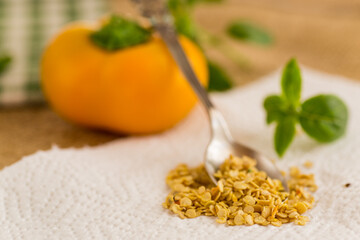 yellow pepper seeds on wooden table