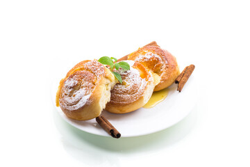 Baked goods. Sweet buns with cottage cheese filling and honey in a plate isolated on a white background