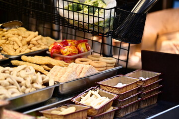 A Taiwanese night market fried food stall with golden fries, onion rings, hash browns, and tempura. These crispy, aromatic treats attract food lovers strolling through the market.