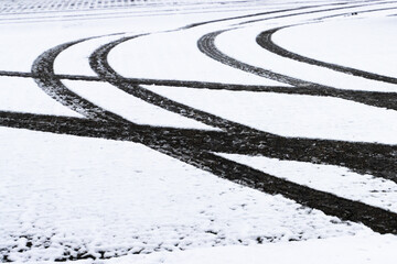 Car Tire Tracks on a Snow-Covered Ground in Winter