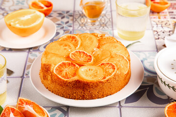 Orange cake with fruit citrus slices.