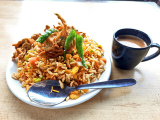 Indian Sweet And Spicy Chaat item sev Puri with piping tea Also Called Bhel Puri. Chat food, India. Mixed chat Stuffed With Potato, Yogurt, Sev, Coriander, Chutney isolated on marble background.