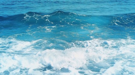 Pure blue turquoise water texture of the ocean sea with foam from and waves