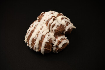 Profiteroles with coconut cream on a black background.