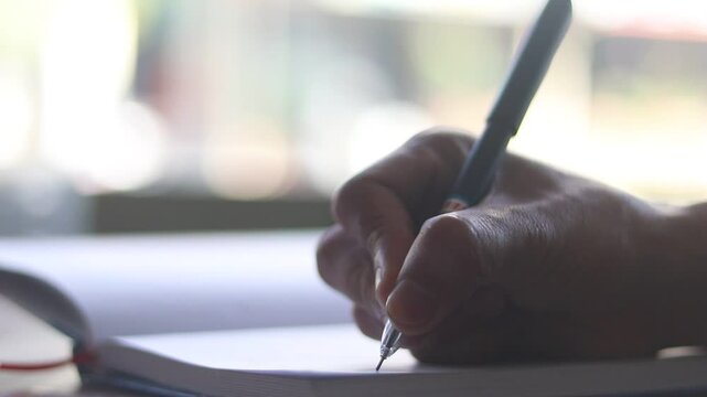 person writing on paper