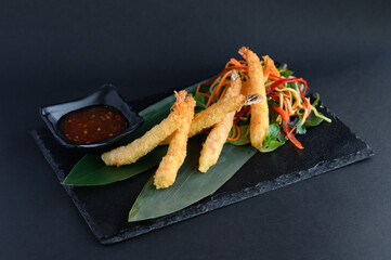 Tempura shrimp served with a variety of dipping sauces, ideal for an Asian restaurant menu.