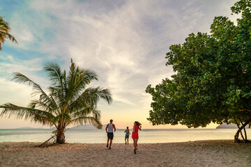 family running on the beach