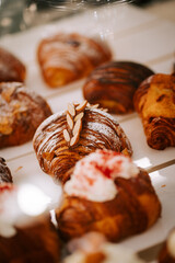 Freshly baked croissants displayed on the counter of a cozy coffee shop in the morning light