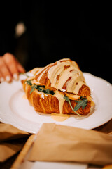 Freshly baked croissant with savory filling served at a local coffee shop during morning hours