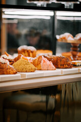 Freshly baked croissants arranged perfectly on the counter of a cozy coffee shop during morning hours