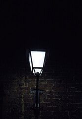 lantern in the night on a brick wall