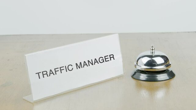 Traffic Manager Office or Room with Hand Ringing The Bell on Desk or Table Multiple Times
