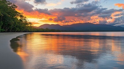 Fototapeta premium Tropical sunset beach, calm water, mountain backdrop, tourism
