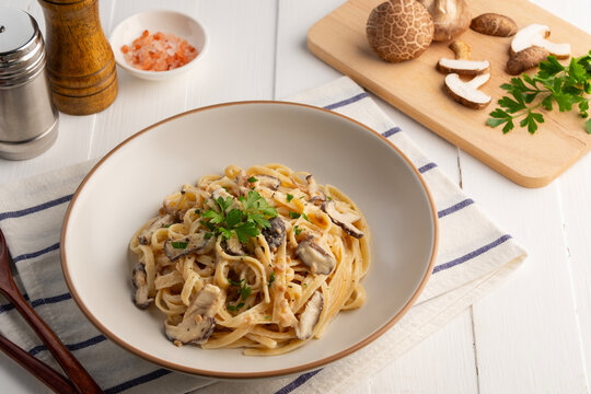 Spaghetti with creamy mushroom sauce,Pasta Linguine with mushrooms and parsley in white plate.Italian traditional dish.