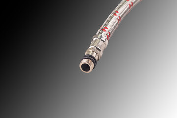 Hose in metal braiding. Designed to connect water to the washbasin. mixer. Close-up.