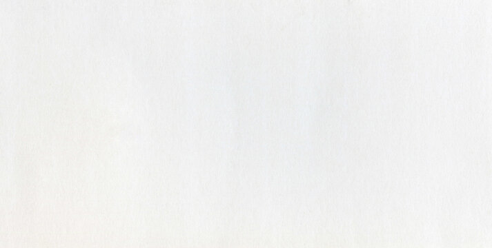 Surface of white paper or cardboard, background, texture. Backdrop of white paper surface with wear traces. Paper piece with elements of light contamination. Smooth, bright, white paper surface