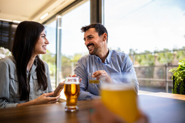 Lovely couple went on a date in a restaurant. Looking at each other and drink coffee.