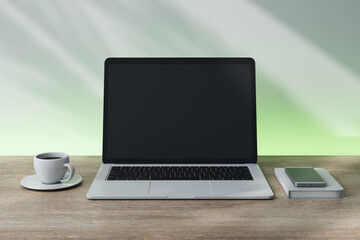 Fototapeta premium Laptop with blank screen on desk with coffee cup, smartphone, and notebook. 3D Rendering