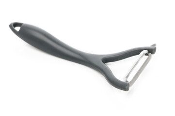 Discovering the art of peeling vegetables with a sleek kitchen tool in bright light