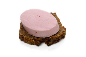 Delightful open-faced sandwich featuring a smooth spread atop dark rye bread enjoyed during a casual lunch