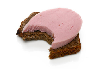 Delicious bite of bread topped with creamy pink spread sits appetizingly on a white surface