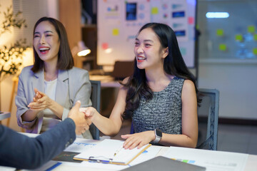 Businesswomen shaking hands after closing a deal during a corporate meeting