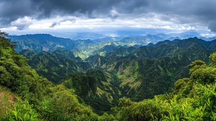 Obraz premium Lush Green Mountainscape Under a Dramatic Cloudy Sky