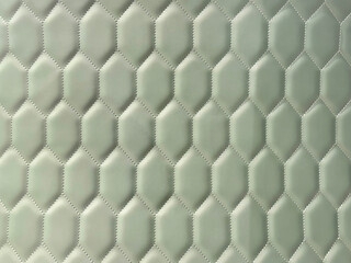 Close up of geometric hexagon shape fabric wallpaper in pale celadon green color. 3D pattern of geometrical hexagon shapes seamless background texture.