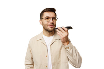 Naklejka premium Man communicates using a voice recorder while standing in a bright setting, focused and attentive