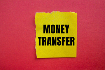 Money transfer message written on ripped torn yellow paper piece with red background. Conceptual money transfer symbol. Copy space.