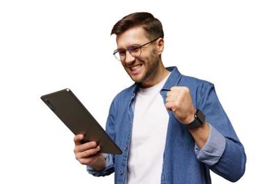 Man celebrates success while using tablet at home in a cheerful moment of achievement