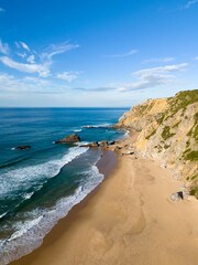 Adraga Beach and Cliffs on Sunny Day. Atlantic Ocean, Portugal. Aerial View.
