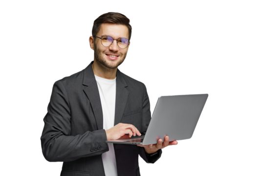 Young professional smiles while using laptop, showcasing modern technology in a minimalist setting