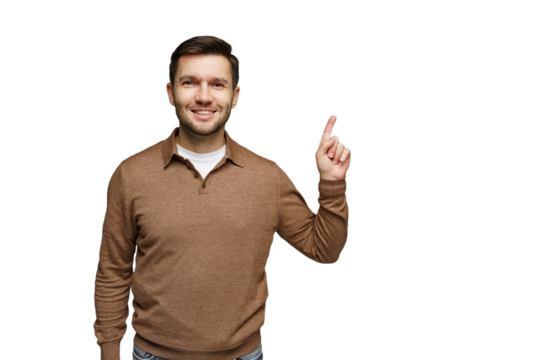 Smiling man wearing a sweater points upward with a cheerful expression in a bright setting