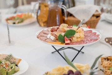 Wedding table with snacks, ham, crayfish and salads