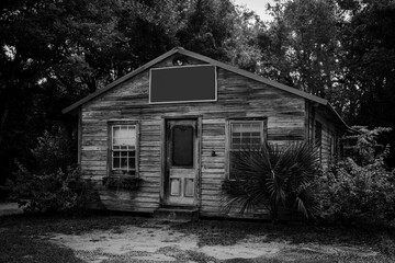 A black and white image of an old, weathered store front in South Georgia USA.
