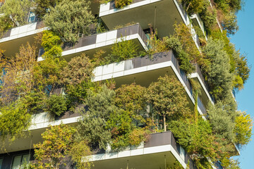 Close up of vertical forest building with lush greenery and trees integrated into modern...