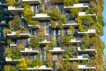 Vertical forest building with lush greenery and trees integrated into modern architecture, Milan,...