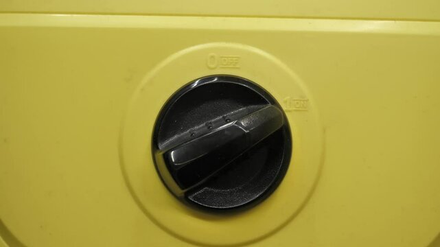 Turn on button, turn switch yellow vacuum cleaner.
turning on the black control on the yellow instrument panel
